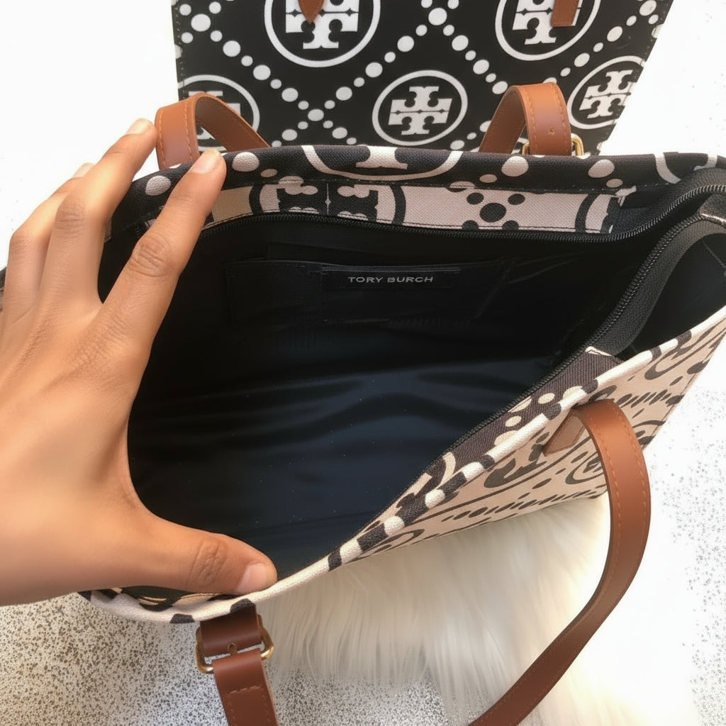 Tory Burch handbag with open lid showing interior, brand name visible.